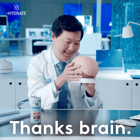 un scientifique qui embrasse un cerveau et qui dit "thanks brain - merci cerveau"